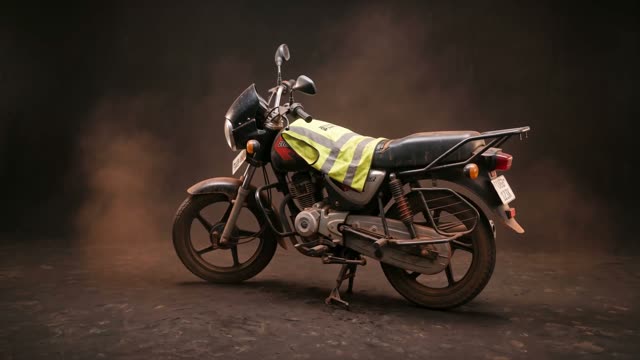 A Bajaj Boxer boda in a warm dark studio void
